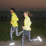 Low Light Speed Tights - Women by Rabbit in black and grey with 360° reflective print, compressive fit, laser-cut perfs, and five pockets for night running.