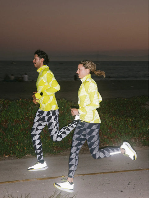 Low Light Speed Tights - Women by Rabbit in black and grey with 360° reflective print, compressive fit, laser-cut perfs, and five pockets for night running.