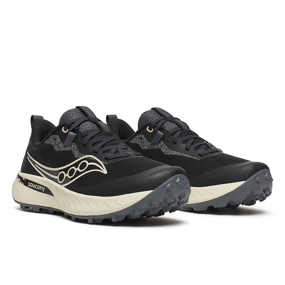 Peregrine 15 - Women by Saucony in black and beige trail shoe with PWRTRAC outsole for durability and grip, ideal for rugged terrain
