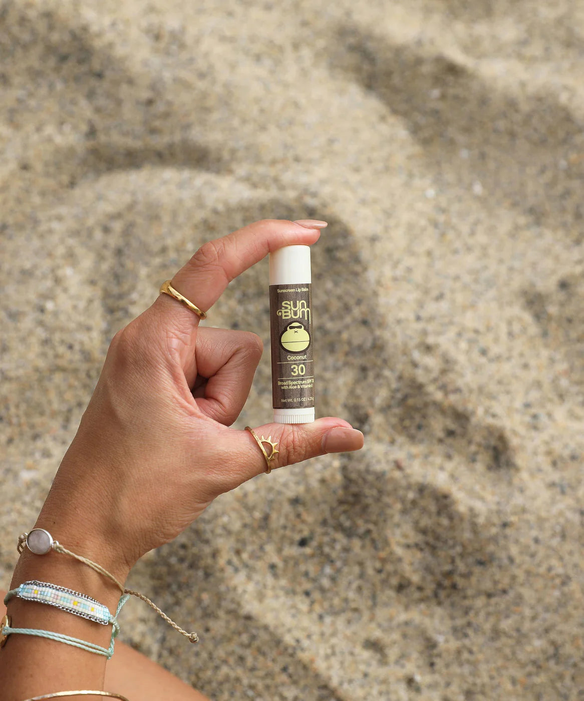 Lipbalm SPF 30 by Sun Bum in brown with white cap, moisturizing lip care with Aloe and Vitamin E for sun protection outdoors