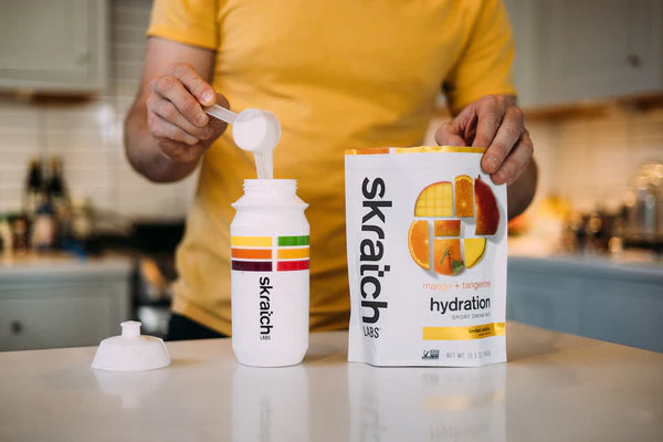 Sport Hydration Drink Mix by Skratch Labs in white and orange packaging, electrolyte drink powder for energy and hydration during workouts