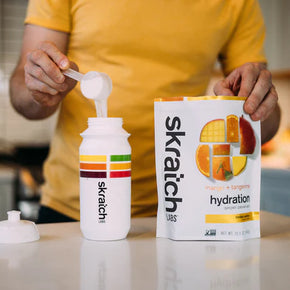 Sport Hydration Drink Mix by Skratch Labs in white and orange packaging, electrolyte drink powder for energy and hydration during workouts