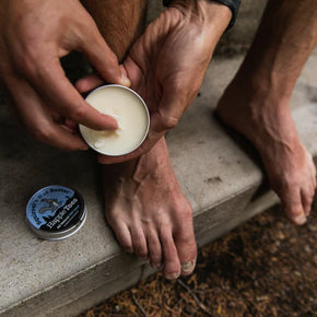 Happie Toes Blend (Metal Tin) by Squirrel's Nut Butter in black tin, foot salve for restoring damaged skin, eco-friendly 2 oz container