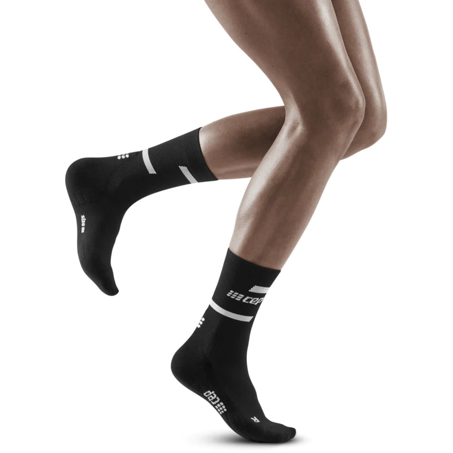 Run Compression Socks 4.0 Mid Cut - Women by CEP Sports in black, stabilizing socks with medi compression for injury prevention in running and training