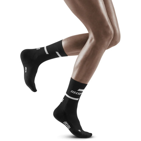 Run Compression Socks 4.0 Mid Cut - Women by CEP Sports in black, stabilizing socks with medi compression for injury prevention in running and training