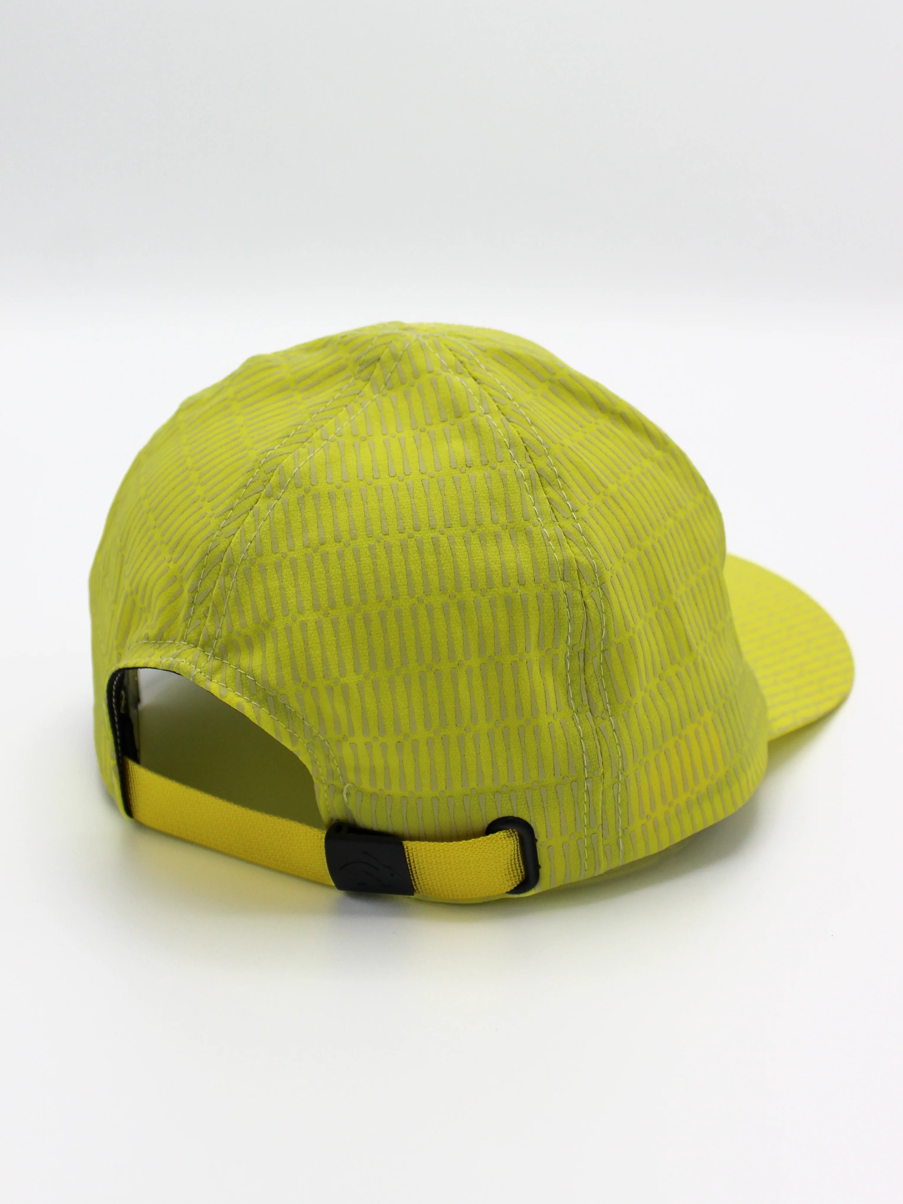Low Light Tech Cap by Rabbit in bright yellow with reflective details, adjustable fit, designed for visibility and safety in low light conditions