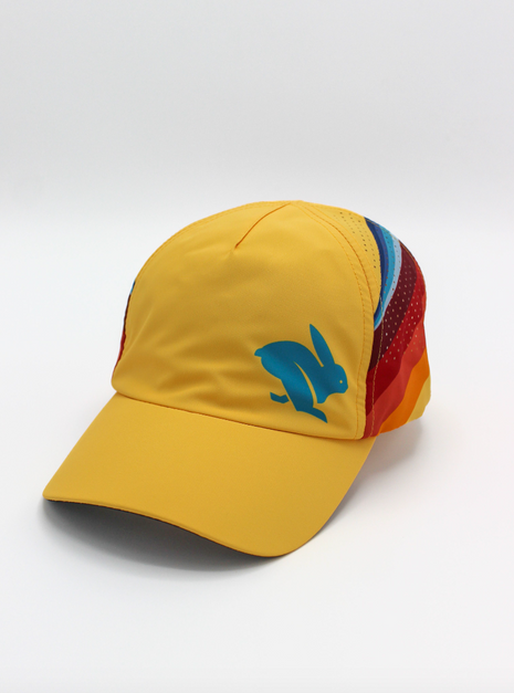 Elite Hat by Rabbit in yellow with rainbow side panels, lightweight wicking cap with laser-cut vents for sun and gear protection