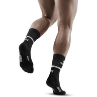 Run Compression Socks 4.0 Mid Cut - Men by CEP Sports in black with white accents, stabilizing and stimulating joints to reduce injuries during running