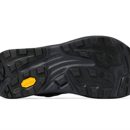 Black lugged Vibram outsole of the Topo Ultraventure 5 GTX women's trail running shoe in Grey/Butter