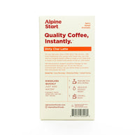 Instant Coffee: Dirty Chai Latte by Alpine Start in white and orange box, spiced Colombian Arabica coffee blend with chai spices and soy milk, instant and quick to dissolve for cozy mornings or on-the-go use