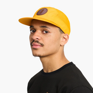 Man wearing the Ciele GOCap Comp Ninety in Solis, three-quarter view showing the brown patch