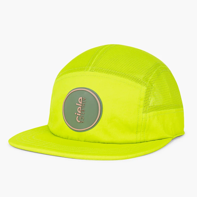 Ciele GOCap Comp Ninety in Gekko, neon yellow five-panel cap with round grey patch, front three-quarter view