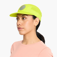 Woman wearing the Ciele GOCap Comp Ninety in Gekko, side three-quarter view with ponytail