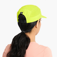Back of a woman's head wearing the Ciele GOCap Comp Ninety in Gekko showing the strap and ponytail