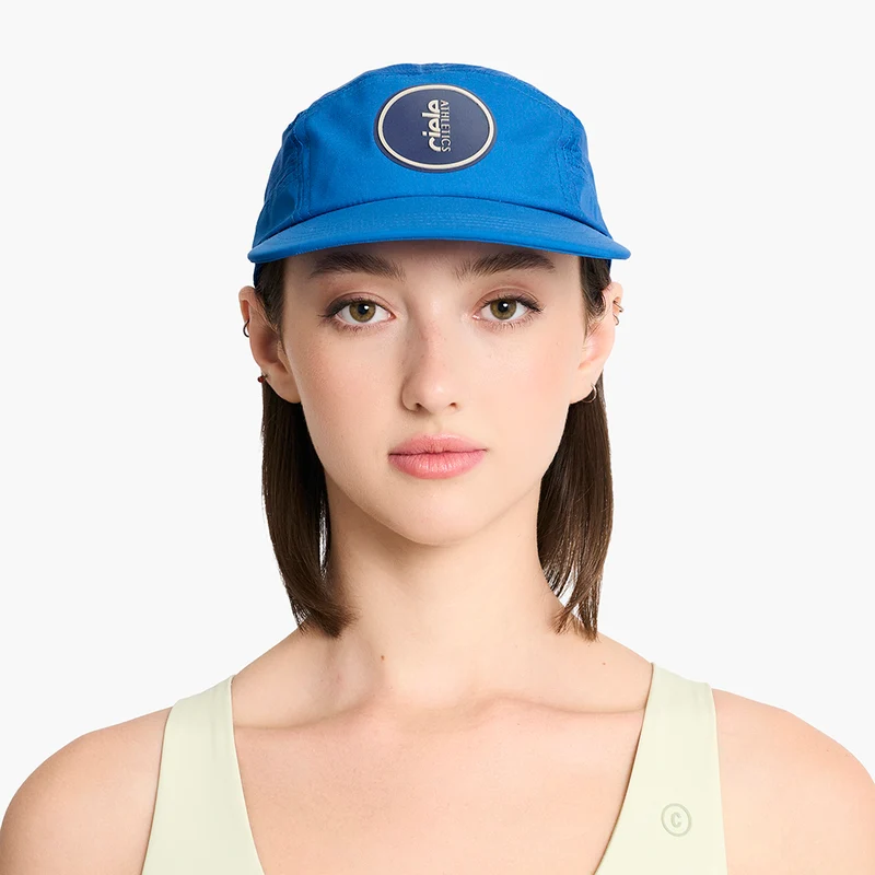 Woman wearing the blue Ciele GOCap Comp Ninety in Azure, front view