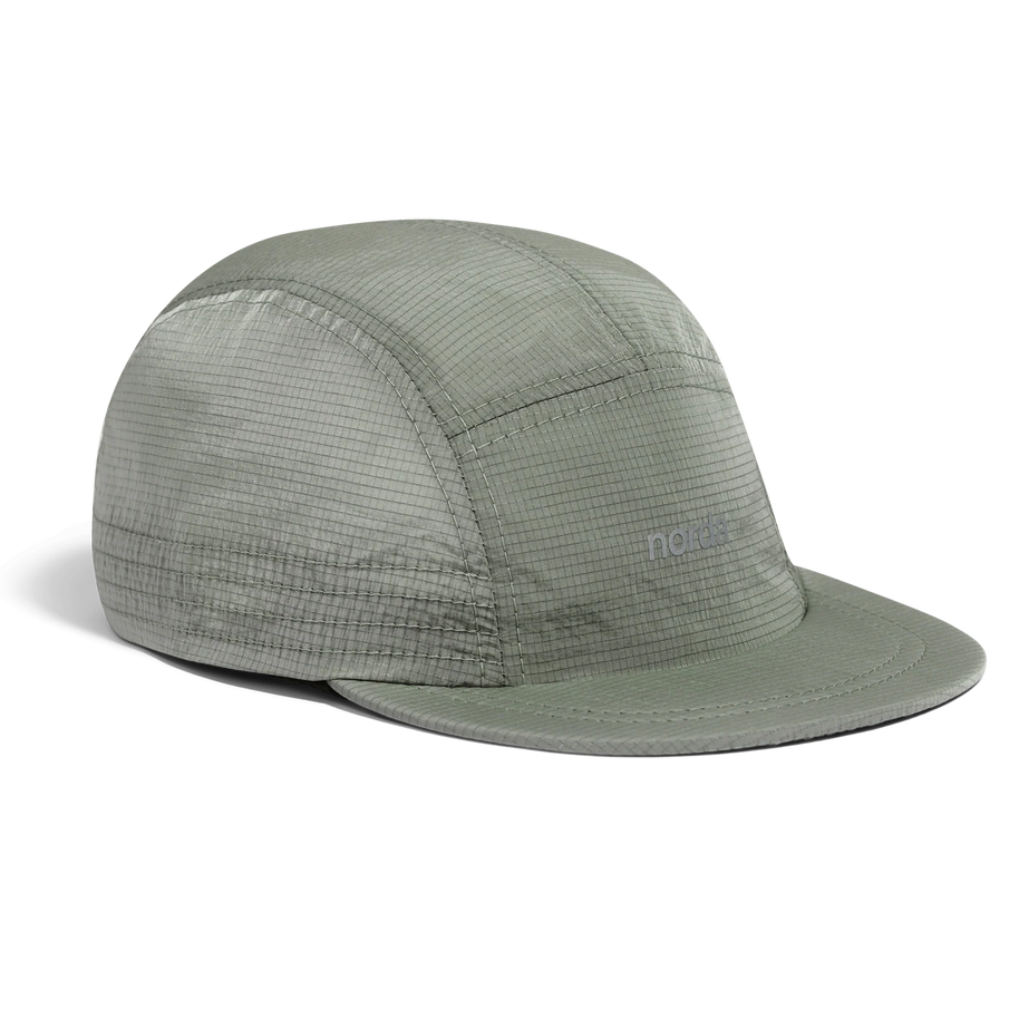 Norda Luster Cap in Sage, side three-quarter view of the sage green ripstop panels and brim