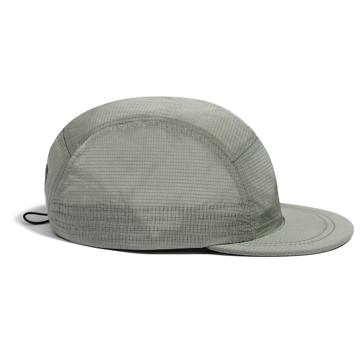 Side view of the Norda Luster Cap in Sage with the cord toggle visible at the back