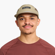 Man in a red shirt wearing the Ciele GOCap - Field - IconicBar in Cub, front view