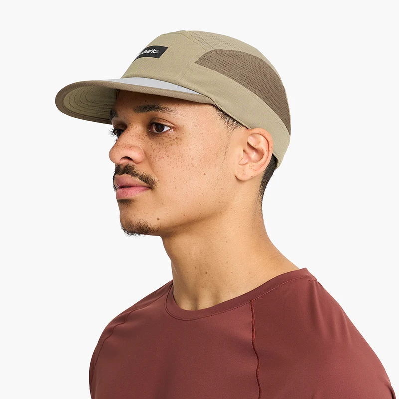 Man wearing the Ciele GOCap - Field - IconicBar in Cub, side profile view
