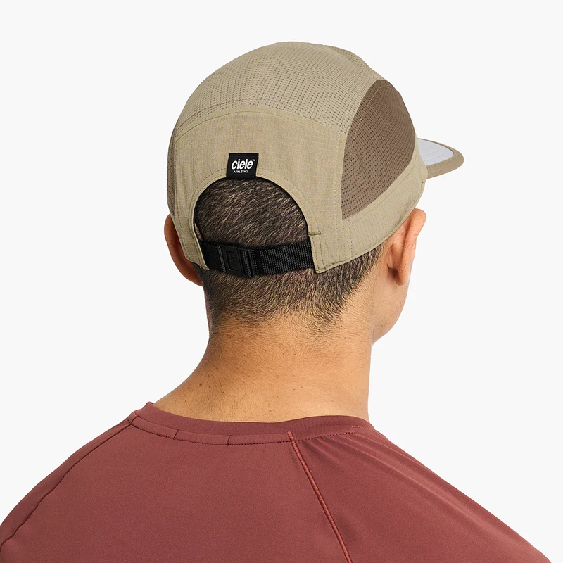 Man wearing the Ciele GOCap - Field - IconicBar in Cub, back view showing the adjustable strap