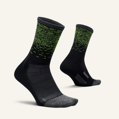 Pair of Feetures Elite Light Cushion Mini Crew socks in Light Wave, black with green dashes, side view