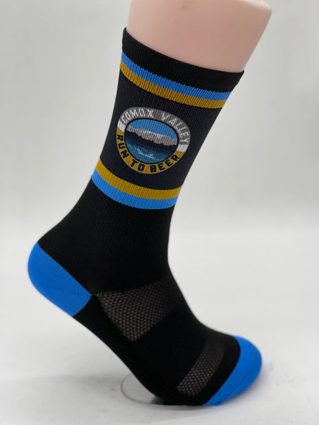 Run to Beer Socks by Outway in black with blue and yellow stripes, supportive socks promoting trail maintenance by United Riders of Cumberland