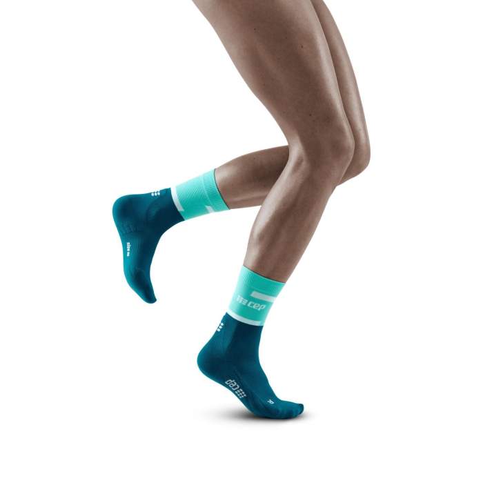 Run Compression Socks 4.0 Mid Cut - Women by CEP Sports in teal and aqua, stabilizing joints with compression for injury reduction during running