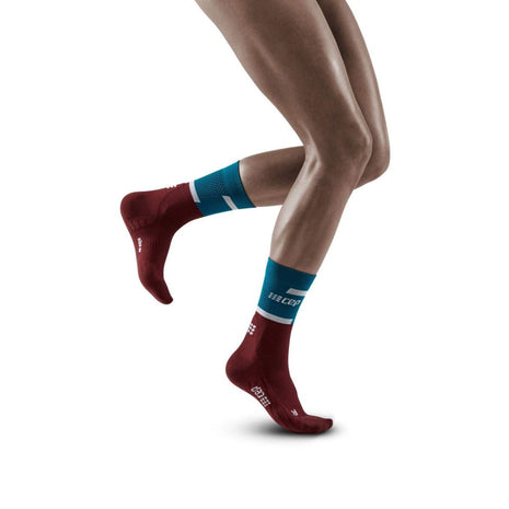 Run Compression Socks 4.0 Mid Cut - Women by CEP Sports in red and blue, compression socks stabilizing joints to reduce injuries for running.
