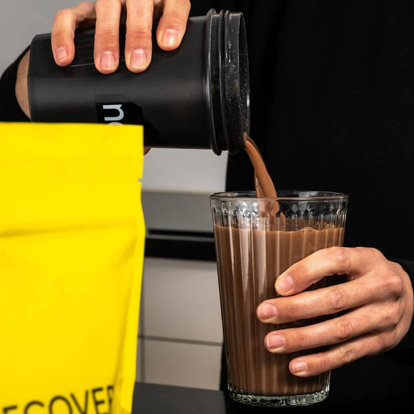 Protein Powder Chocolate by Naak in yellow pouch, high-protein recovery powder for endurance athletes supporting muscle building and rehydration