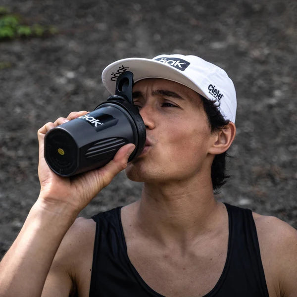 Protein Powder Vanilla by Naak in black shaker bottle, high-protein recovery powder for endurance athletes to build muscle and aid rehydration