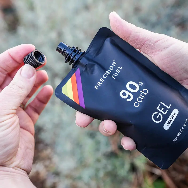 PF Gel by Precision Fuel & Hydration in black pouch with colorful stripe, citrus-flavored gel delivering 90g carbs for fast energy boost during running