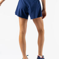 Fuel 'N Fly 4 - Women by Rabbit in navy blue shorts with back zip pocket and multiple pockets for long-distance running essentials