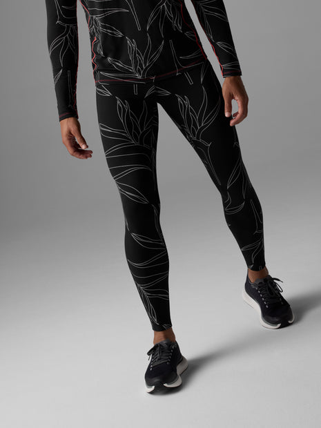 Man walking in Rabbit Low Light Pocket Tightz men's tights in Black Reflective, front view from waist down