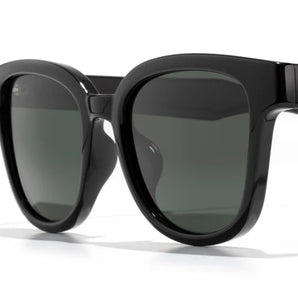 Miho by Sunski in black with dark green lenses, stylish sunglasses with timeless curved design ideal for beach and casual wear