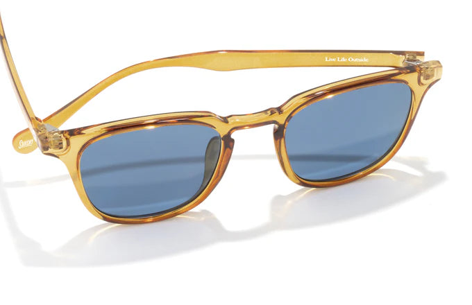 Tango by Sunski in translucent amber with blue polarized Helio lenses, superlight recycled frame, plastic-free, lifetime warranty sunglasses