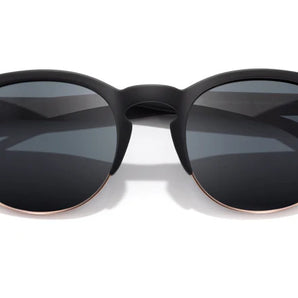 Avila by Sunski in black and gold half frame sunglasses with metal details and no wire nose pads for versatile everyday wear