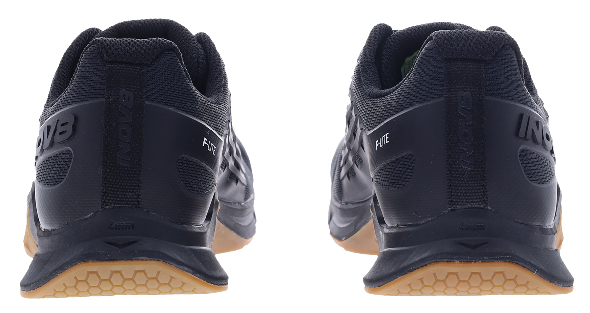 Back view of a pair of Inov8 F-Lite Wide women's training shoes in Black/Gum with black heels and gum soles