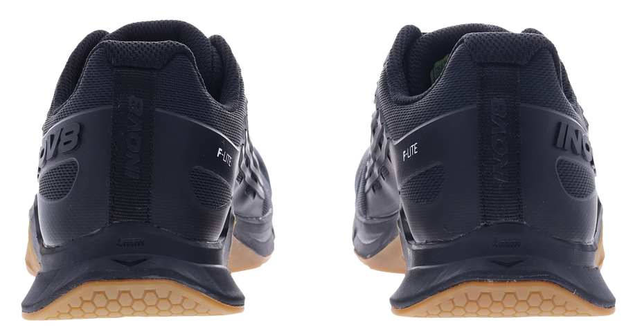 Back view of a pair of Inov8 F-Lite Wide women's training shoes in Black/Gum with black heels and gum soles