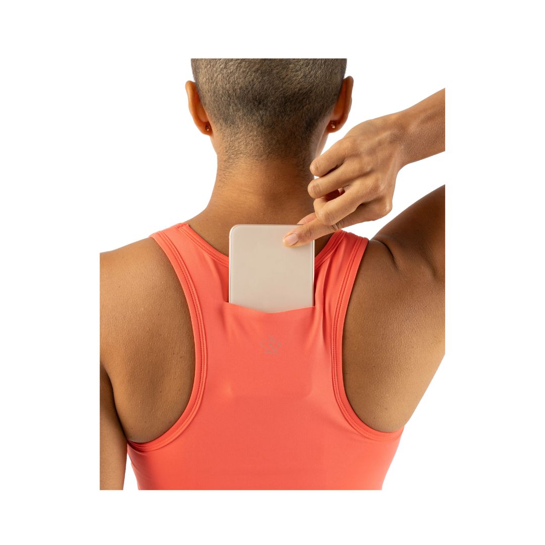 Utili Bra-Vo by Rabbit in coral, multifunctional sports bra with laser-cut back pocket for secure essentials, ideal for running and active use