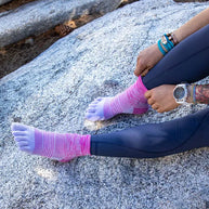 Trail Midweight Mini-Crew - Women by Injinji in pink and purple cushioned toesocks designed for comfort and support on uneven trails