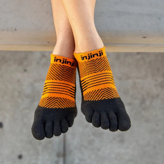 Run Lightweight No-Show - Women by Injinji in orange and black low-bulk toe socks with narrow fit and stretch for running