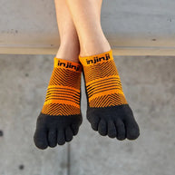 Run Lightweight No-Show - Women by Injinji in orange and black low-bulk toe socks with narrow fit and stretch for running
