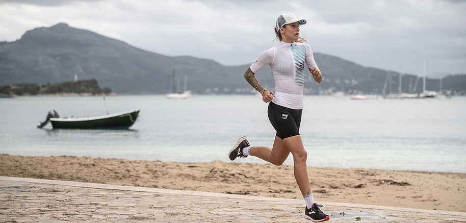 Racing Trucker Cap by Compressport in white and grey, stylish lightweight headwear for high-performance running and outdoor training