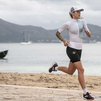 Racing Trucker Cap by Compressport in white and grey, stylish lightweight headwear for high-performance running and outdoor training