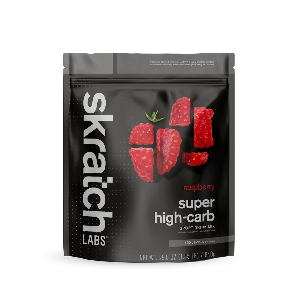 Super High-Carb Sport Drink Mix raspberry by Skratch Labs in black pouch, high-calorie nutrition for athletes needing fast energy fueling.