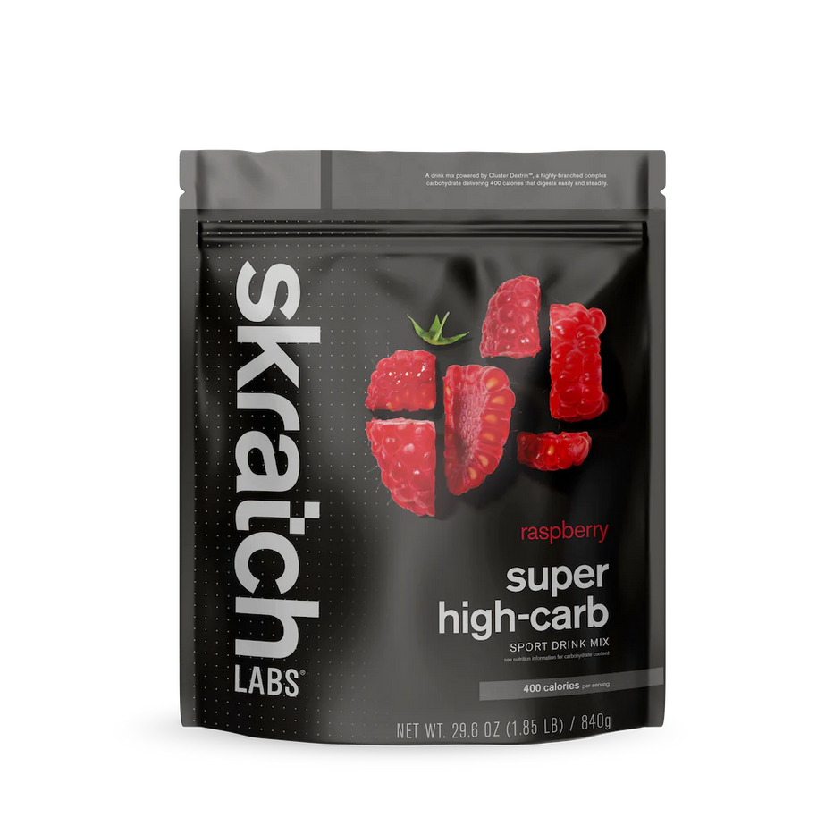 Super High-Carb Sport Drink Mix raspberry by Skratch Labs in black pouch, high-calorie nutrition for athletes needing fast energy fueling.