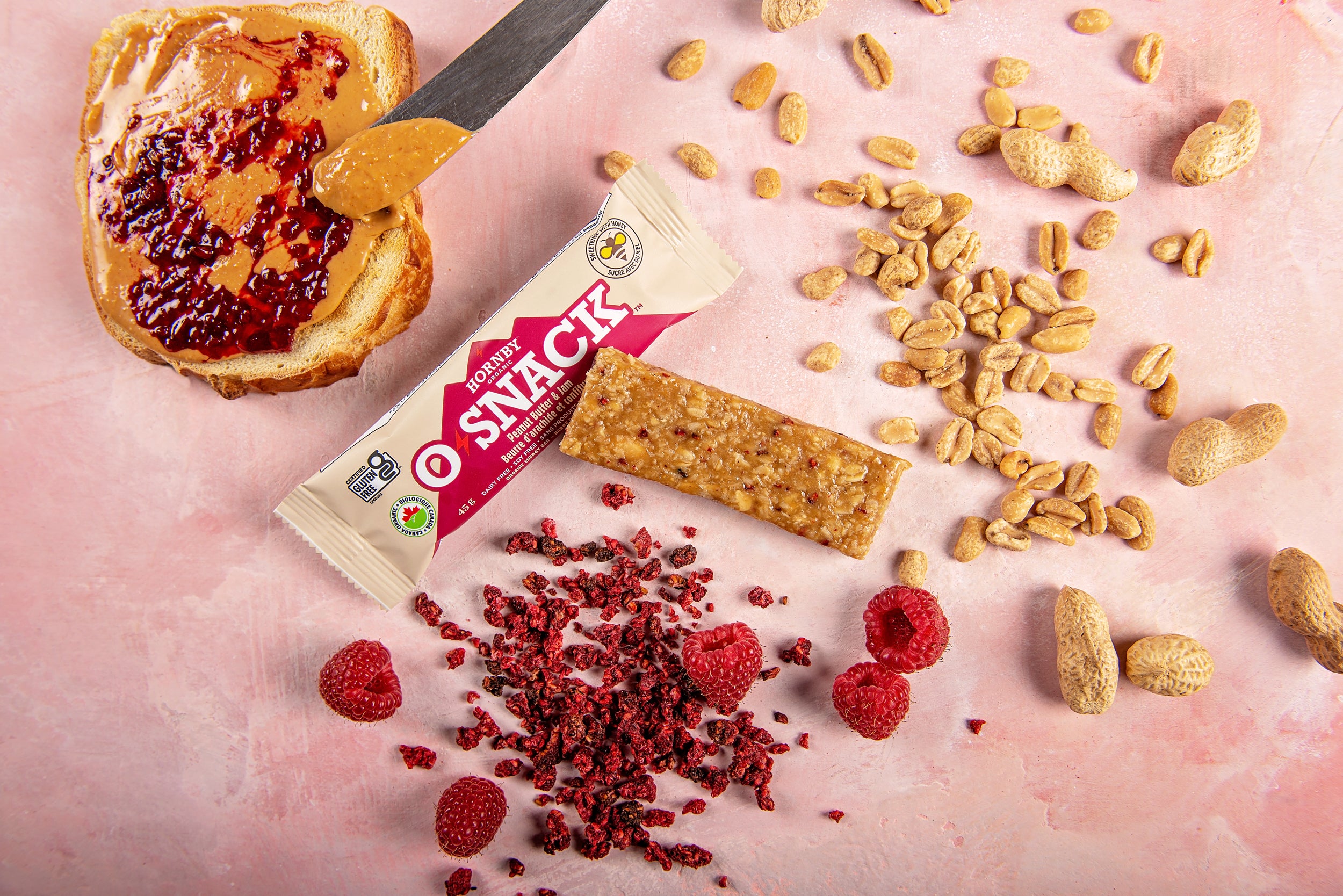 OSnack Peanut Butter & Jam by Hornby Organic in red and beige with organic peanut and raspberry flavour snack bar for nutrition and energy