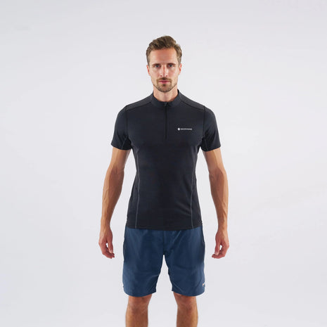 Man wearing the Montane Dart Zip T-Shirt in Black with blue shorts, front view