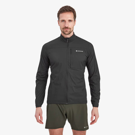 Man wearing the Montane Featherlite Jacket in Black with olive shorts, front view