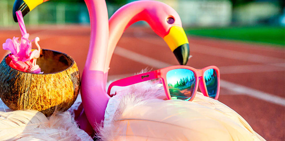 Flamingos On A Booze Cruise by Goodr in bright pink with teal lenses, fun running glasses inspired by flamingo colors for outdoor use